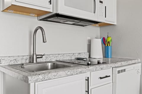 Perfect little kitchenette with 2 burner cooktop, microwave, and dishwasher. We also have a crock pot.