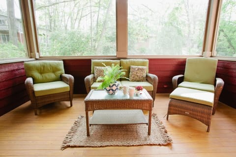 This bright and peaceful sunroom offers a twin daybed and tranquil forest views—great as a reading nook or an extra sleeping space.