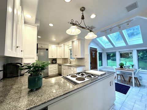 Full size kitchen with granite countertop and all essential appliances.