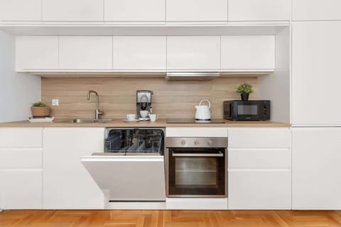 Kitchenette with plenty of kitchen utensils and dishes.