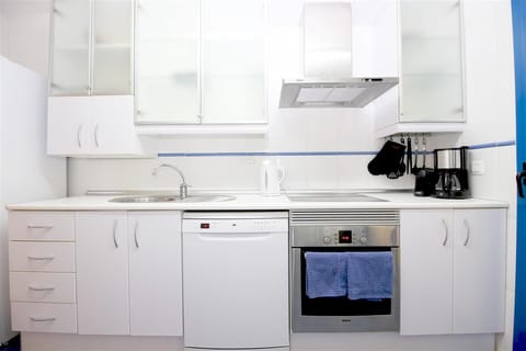 Kitchen in this apartment is fully fitted with all the appliances
