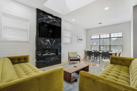 Welcome to Vista Montana! Our modern retreat in Historic Downtown Monument, your perfect getaway! Enjoy our inviting living room with large windows, a sleek modern fireplace, and cozy seating for relaxation.
