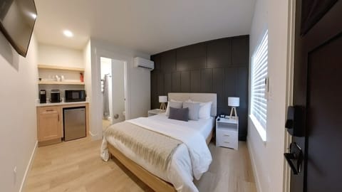 Relax in this modern studio featuring a full-size bed, soft linens, and a chic, minimalist design.