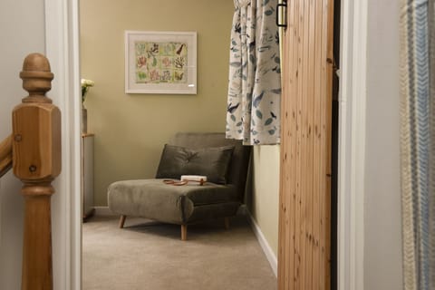 Bowjy Cottage, St Agnes. Second Floor: This lovely chair converts into a single bed