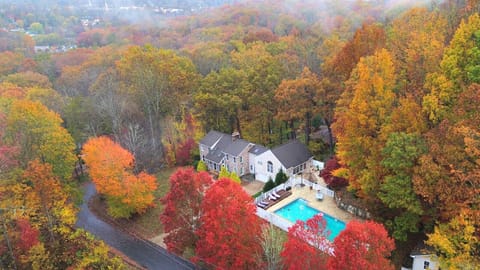 Gorgeous modern home with virtually every amenity, nestled in private wooded area with beautiful fall foliage