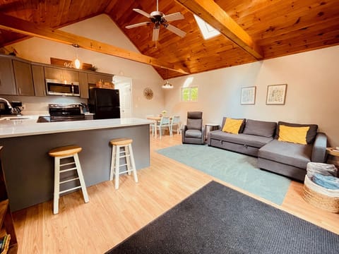 Open concept living room, kitchen and dining area.