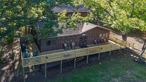 Relax and take in the beauty of nature from this stunning wraparound porch! Whether you're sipping coffee in the morning, grilling out, or unwinding under the string lights at night, this space is perfect for enjoying nature with family and fr