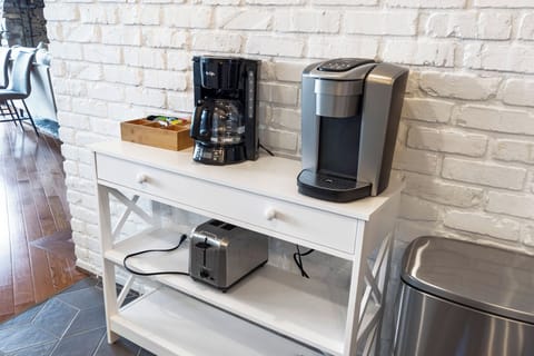 Kitchen with stainless appliances, dishwasher, Keurig and drip-style coffee pot, and access to the garage.