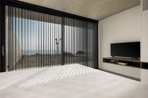 This bedroom also features, an ensuite bathroom with a stand-up shower, an open closet, a 43” TV, a self-controlled A/C, and direct access to the outdoor area.