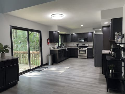 The large and open kitchen, adjacent to the living room, dining room, game room, laundry, and half bath.