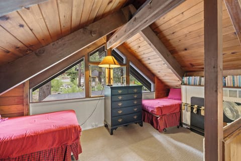 Loft with books and twin beds