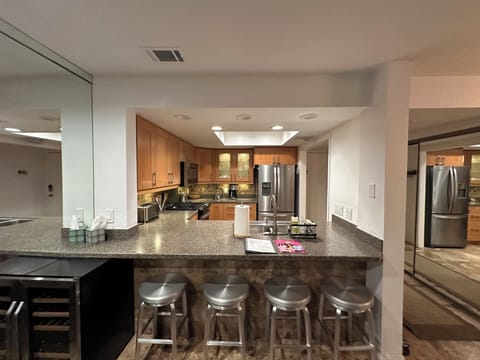 Open bar seating bridges the living room and kitchen for entertaining