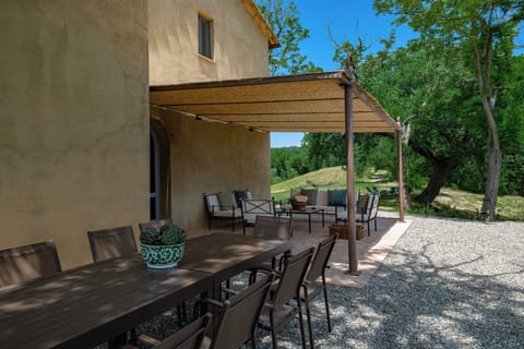 Dine under the pergola and enjoy sunset over the Tuscan hills.