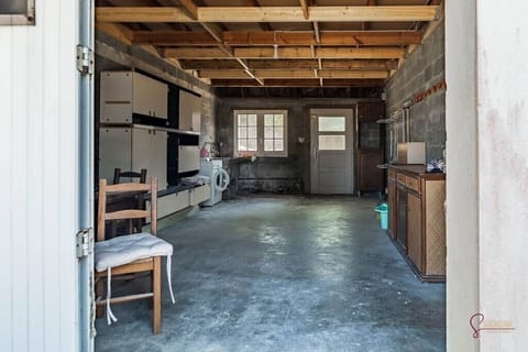 Garage avec lave linge pour stocker le matériel nautique et les vélos