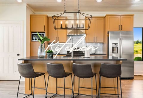 Meet the kitchen of your dreams! It has a big island, stainless steel appliances, and plenty of room to whip up your favorite meals.