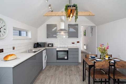 Kitchen area with microwave, electric hob and oven