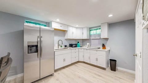 The quaint kitchen space offers charm and functionality, featuring essential appliances, ample storage, and a cozy atmosphere for preparing meals with ease.