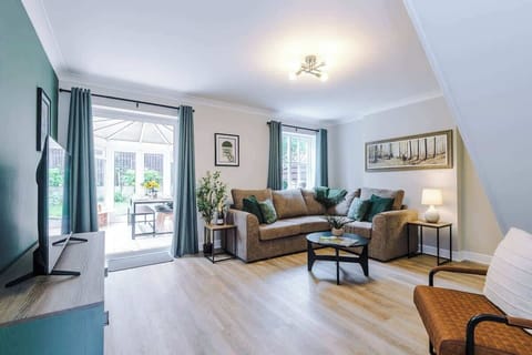 The spacious living space benefits from a comfortable sofa bed, a 40-inch smart TV and plenty of space to sit down and relax.