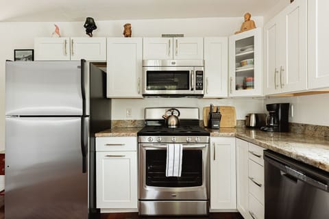 Open concept kitchen featuring drip coffee maker.