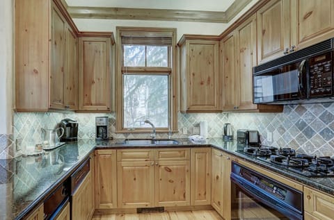 Cook up delicious meals in the modern kitchen, featuring stainless steel appliances, granite countertops, and plenty of cabinet space.
