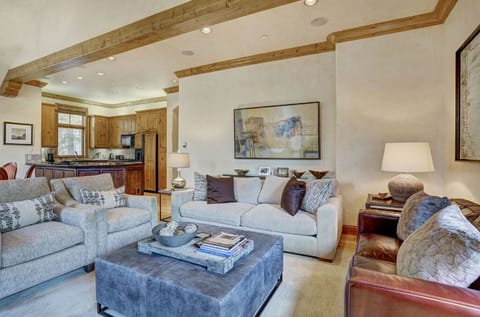 Relax in the second living room, offering additional seating, a flat-screen TV, and a warm, inviting atmosphere perfect for gatherings.