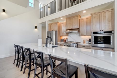 Modern kitchen with high-end appliances, large island, and stunning views.