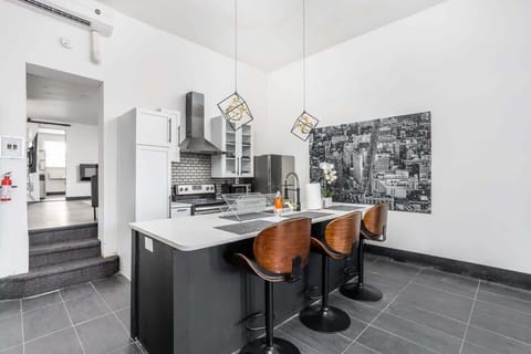 Pristine kitchen with bar seating and artistic accents