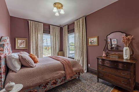 Embrace the tranquility of a pastel sanctuary, where the pink walls and queen bed invite you to unwind and find peace. 🌸 #BedroomBliss