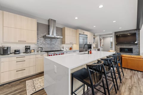 Full kitchen with stainless steel appliances and breakfast bar with seating for 4.