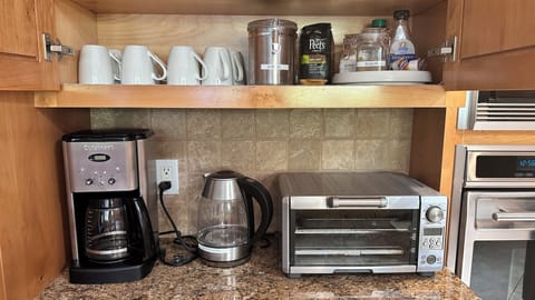 Coffee maker and electric kettle, Coffee, tea, sugar and cream are available.