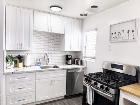 Enjoy a sleek, modern kitchen equipped with stainless steel appliances, full cookware, and essentials for home-style meals.