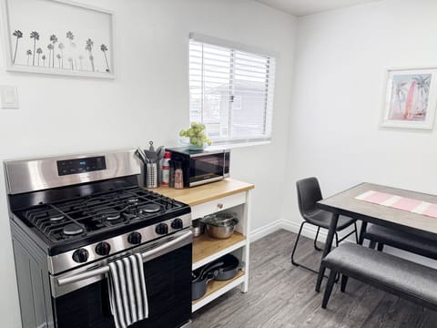 Casual dining area with a bench-style table for four, plus extra kitchen prep space and all the cookware you need.