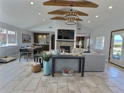 The entire space is elegantly decorated with stylish furnishings and vibrant accents, creating a warm and welcoming atmosphere.