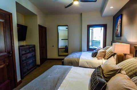 Welcome guests to this inviting bedroom, featuring a cozy bed, soft linens, and ample natural light for a comfortable stay.
