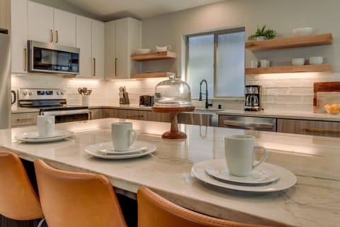 - Kitchen island with marble countertops
- Stainless steel appliances and modern design
- Perfect spot for coffee and quick meals