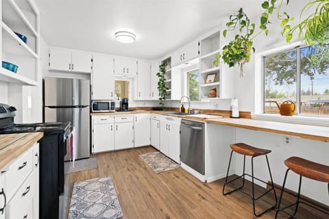 Spacious, family-ready kitchen with cookware, dishes, cutlery, and a Keurig.