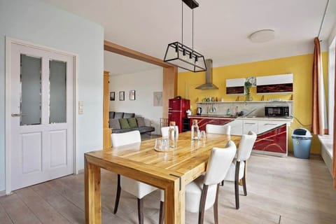 Ambient photo of the dining table and kitchen