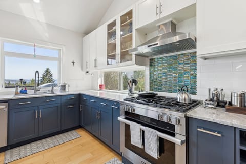 Large kitchen with quartz countertops and professional grade range and dishwasher.