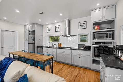 Fully-equipped luxury kitchen with fridge, stove, oven, microwave, coffee maker, dishwasher, pots/pans, silverware, etc...