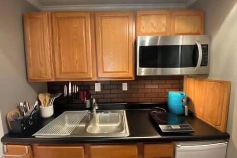 Fridge, microwave, coffee/tea maker, cookware/dishes/utensils