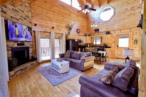 Open concept living room with a view into the dining area and kitchen.