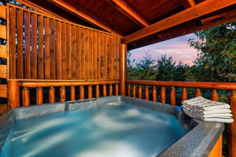 Rejuvenating hot tub on deck surrounded by nature, offering a peaceful escape.
