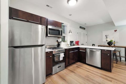 A sleek and modern kitchen equipped with stainless-steel appliances, rich wood cabinetry, and plenty of counter space. Perfect for cooking meals, enjoying morning coffee, or prepping snacks for your stay.