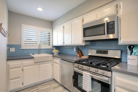 Perfect for quick meals or preparing snacks before heading out to the beach, this kitchen blends function and style with ease.