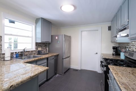 Kitchen and door to laundry/supply room.