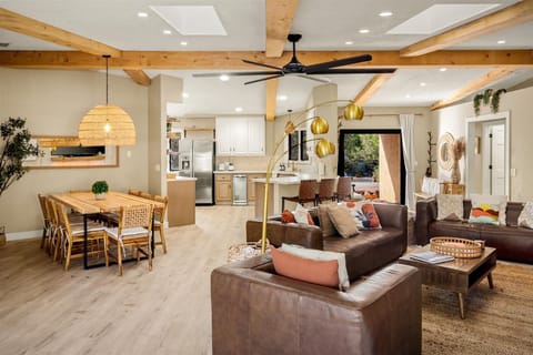 "Experience Effortless Living with Our Seamlessly Connected Living Room, Dining Area, and Kitchen