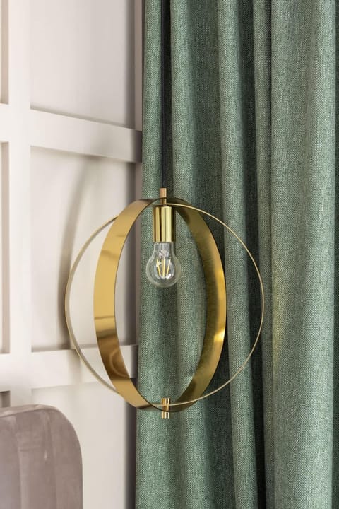 A lamp next to the bed, giving the interior elegance.