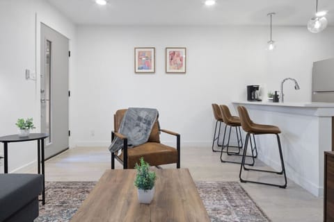 Prepare meals in this modern, fully-equipped kitchen featuring stainless steel appliances and a spacious island with bar seating. The open layout makes it easy to cook and entertain, ensuring a delightful culinary experience during your stay.