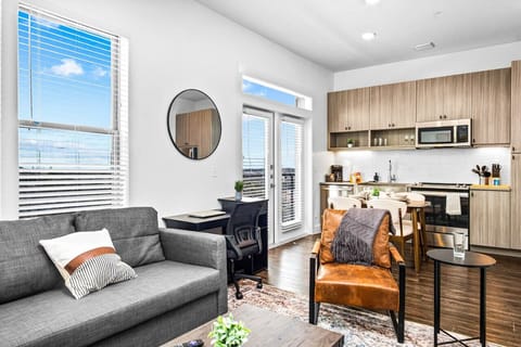 Bright and airy living room with plush seating, a large TV, and tasteful decor, creating the perfect space for relaxation and entertainment.
