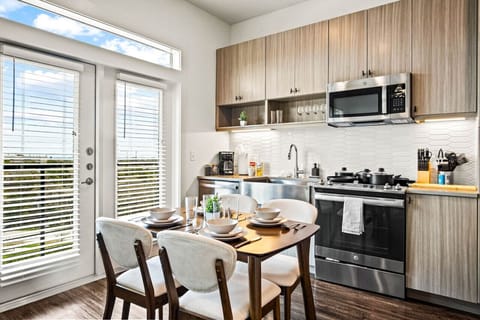 Set the table for memorable meals in this beautifully arranged dining area. With elegant place settings and a charming centerpiece, it's perfect for hosting dinner parties or enjoying family dinners in a cozy and stylish atmosphere.